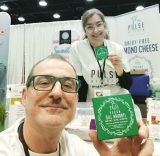 pulse kitchen co-founders Stephanos Liapis and Brigette holding up cheese